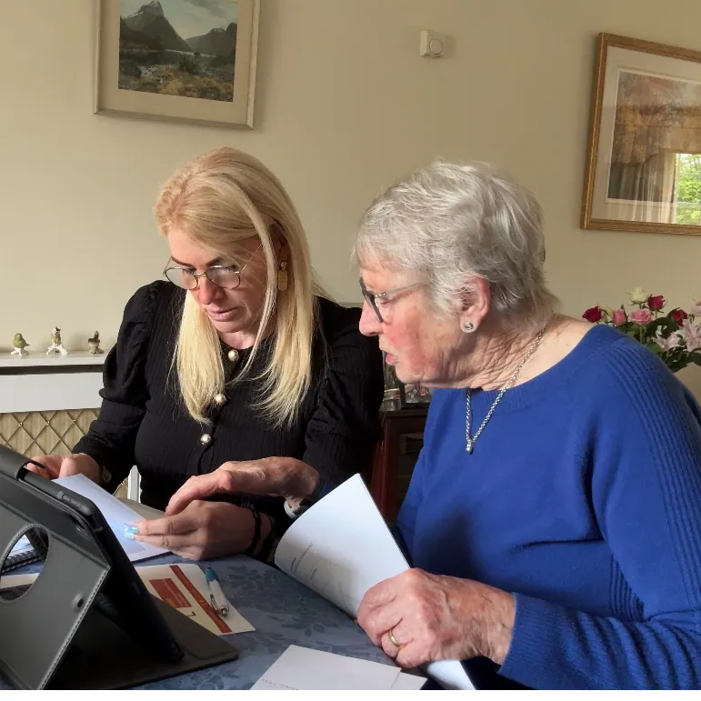 Caro Syson, founder of Your Final Matters, going through paperwork with an older woman at a table
