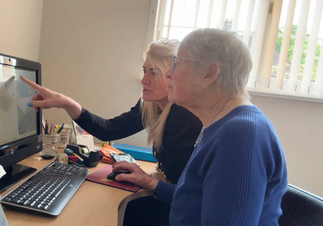 Caro Syson, founder of Your Final Matters, helping an older woman at a computer