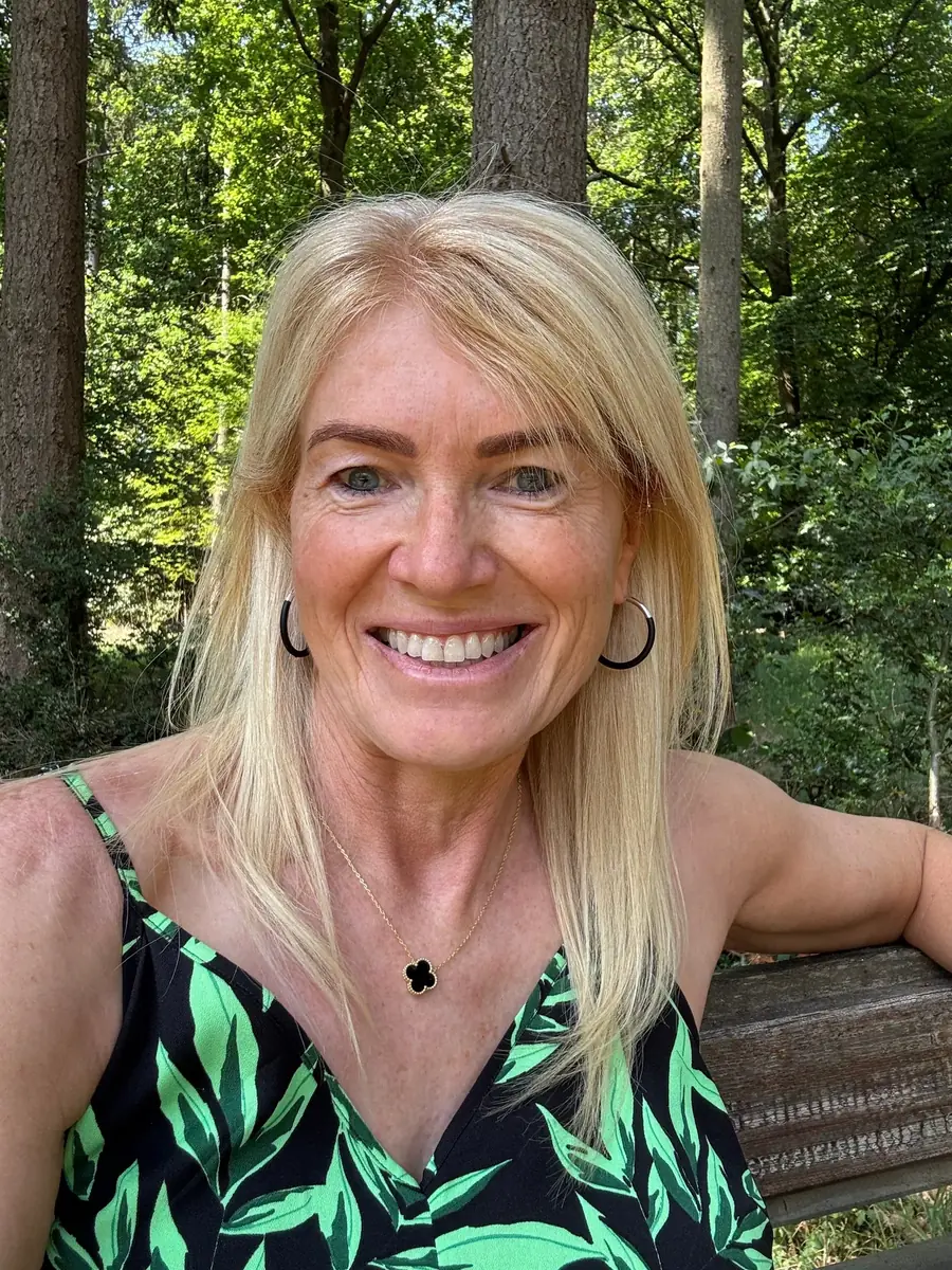 Caro Syson, founder of Your Final Matters, smiling outdoors among trees